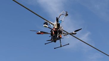O conceito de drone quadcopter agarra linhas de energia para recarregar suas baterias